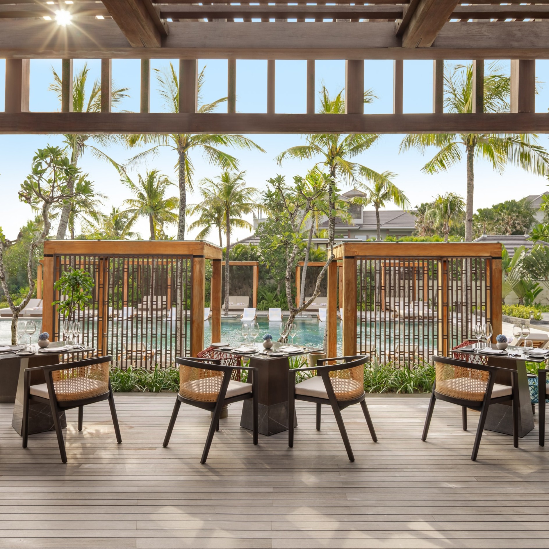 Poolside outdoor dining at Taru surrounded by tropical gardens
